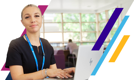 Corporate NHS professional smiling in front of a laptop