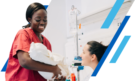 NHS International healthcare professional supporting a patient with a baby in a hospital setting