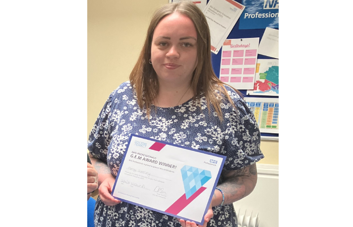 Amy from Southern Health NHS Foundation Trust holding their GEM Awards prize.